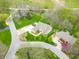 Aerial view of a neighborhood highlighting manicured lawns, mature trees, and the serene residential community at 2733 Foxborough Dr, Greenwood, IN 46143