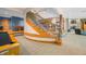 Finished basement with a curved staircase, a pool table, and a cozy fireplace, ideal for entertainment and relaxation at 2733 Foxborough Dr, Greenwood, IN 46143
