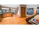Basement featuring wood floors, a staircase, and a door to a blue-walled room with a shuffleboard table at 2733 Foxborough Dr, Greenwood, IN 46143