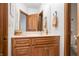 Bathroom vanity with wood cabinets, a framed mirror, and a neutral color palette at 2733 Foxborough Dr, Greenwood, IN 46143