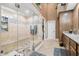 Bright bathroom featuring an updated glass shower, a cabinet, and a tile floor at 2733 Foxborough Dr, Greenwood, IN 46143