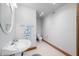 Bathroom with pedestal sink, round mirror, toilet, and neutral finishes at 2733 Foxborough Dr, Greenwood, IN 46143