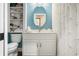 Bathroom featuring white vanity with framed mirror, floral curtains, and built-in shelves at 2733 Foxborough Dr, Greenwood, IN 46143