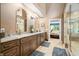 Bathroom featuring double sinks with granite countertops and tile floors, plus an adjacent glass shower at 2733 Foxborough Dr, Greenwood, IN 46143