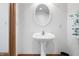 Charming powder room featuring an oval mirror and pedestal sink at 2733 Foxborough Dr, Greenwood, IN 46143