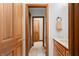 Hallway view of a bathroom, showcasing the vanity and a glimpse into a bright hallway beyond at 2733 Foxborough Dr, Greenwood, IN 46143