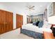 Bright bedroom featuring a ceiling fan, two closets, and soft natural light from a large window at 2733 Foxborough Dr, Greenwood, IN 46143