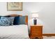 A bedside table with three drawers sits next to the bed in this inviting bedroom at 2733 Foxborough Dr, Greenwood, IN 46143