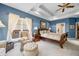 Elegant primary bedroom with a large window, tray ceiling, and an inviting seating area featuring a tufted ottoman at 2733 Foxborough Dr, Greenwood, IN 46143