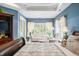 Bedroom with a cozy sitting area featuring a sofa and windows at 2733 Foxborough Dr, Greenwood, IN 46143