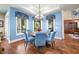Dining area features a round wood table, blue chairs, and lots of windows with wooded views at 2733 Foxborough Dr, Greenwood, IN 46143