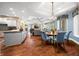 Cozy dining area with wood floors, a decorative light fixture, and blue upholstered chairs at 2733 Foxborough Dr, Greenwood, IN 46143
