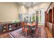 Dining room features a chandelier, large windows, hardwood floors, and a built-in bar area at 2733 Foxborough Dr, Greenwood, IN 46143