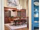 Dining area showcasing a chandelier, hardwood floors, and custom built-in wood cabinetry at 2733 Foxborough Dr, Greenwood, IN 46143
