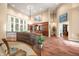 Upstairs view featuring dining room with custom wood cabinets, chandelier, and access to additional living spaces at 2733 Foxborough Dr, Greenwood, IN 46143