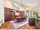Elegant dining room featuring a chandelier, custom wood cabinetry, and hardwood flooring at 2733 Foxborough Dr, Greenwood, IN 46143