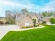 Spacious brick home with manicured lawn, mature trees, and circular driveway at 2733 Foxborough Dr, Greenwood, IN 46143