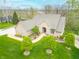 Stunning home featuring manicured lawn, brick facade, complemented by verdant greenery, mature trees, and a charming walkway at 2733 Foxborough Dr, Greenwood, IN 46143