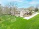 Stunning multi-story home featuring stone facade, balconies, and manicured lawn at 2733 Foxborough Dr, Greenwood, IN 46143