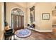 Elegant foyer with hardwood floors, arched doorway, decorative mirror, and stylish furnishings at 2733 Foxborough Dr, Greenwood, IN 46143