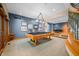Open game room with billiard table, wet bar, and seating area for entertaining at 2733 Foxborough Dr, Greenwood, IN 46143