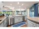 Bright kitchen with granite counters, stainless appliances, hardwood floors, and open view to Gathering and dining rooms at 2733 Foxborough Dr, Greenwood, IN 46143