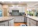 The kitchen features stainless appliances, granite counters, and gray cabinets at 2733 Foxborough Dr, Greenwood, IN 46143