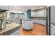 Bright kitchen with center island, granite counters, stainless appliances, hardwood floors, and open to dining and living spaces at 2733 Foxborough Dr, Greenwood, IN 46143