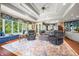 Spacious living room featuring a large window seat, decorative ceiling, and plush seating arrangement at 2733 Foxborough Dr, Greenwood, IN 46143