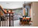 Well lit living room with dining area, large windows with view, and wrought iron staircase at 2733 Foxborough Dr, Greenwood, IN 46143