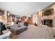 Cozy basement with a brick fireplace, a wet bar, comfortable seating, and a textured carpet at 2733 Foxborough Dr, Greenwood, IN 46143