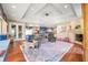 Bright living room features a fireplace, wood floors, large area rug and coffered ceilings at 2733 Foxborough Dr, Greenwood, IN 46143