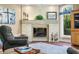 Comfortable living room featuring a stone fireplace, hardwood floors, and natural light at 2733 Foxborough Dr, Greenwood, IN 46143
