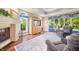 Bright living area showcasing large windows, a stone fireplace, hardwood floors, and comfortable seating at 2733 Foxborough Dr, Greenwood, IN 46143
