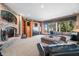 Living room with a fireplace, a large window, carpeted floors, and a comfortable sectional sofa at 2733 Foxborough Dr, Greenwood, IN 46143