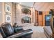 Living room with a brick fireplace, wooden cabinets, and a comfortable seating area at 2733 Foxborough Dr, Greenwood, IN 46143