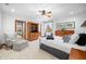 Spacious bedroom with sitting area, ceiling fan and multiple doors leading to other rooms at 2733 Foxborough Dr, Greenwood, IN 46143