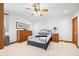 This primary suite features a ceiling fan, decorative pillows, and carpeted floor at 2733 Foxborough Dr, Greenwood, IN 46143