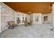 Relaxing covered patio with brick columns, tiled floor, and outdoor seating area at 2733 Foxborough Dr, Greenwood, IN 46143