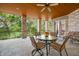 Inviting covered patio with brick pillars, wood ceiling, and comfortable seating at 2733 Foxborough Dr, Greenwood, IN 46143