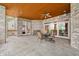 Elegant covered patio with brick columns, tiled floor, and outdoor seating area at 2733 Foxborough Dr, Greenwood, IN 46143