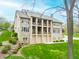 Beautiful backyard with multiple balconies, lush lawn, and stone facade on a multi-story home with ample natural light at 2733 Foxborough Dr, Greenwood, IN 46143