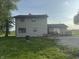 Back exterior shot of home; features a deck and gravel backyard at 3008 N Michigan Rd, Shelbyville, IN 46176