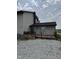 The backyard deck area features sliding glass doors and gravel landscaping at 3008 N Michigan Rd, Shelbyville, IN 46176