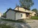 Two-story home showcases a covered porch and classic siding, enhanced by the surrounding green space at 3008 N Michigan Rd, Shelbyville, IN 46176