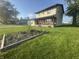 Inviting two-story home with a covered front porch, complemented by a green lawn and gardening beds at 3008 N Michigan Rd, Shelbyville, IN 46176