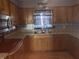A traditional kitchen with wooden cabinets, decorative backsplash, and updated countertops at 3008 N Michigan Rd, Shelbyville, IN 46176