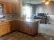 Open concept kitchen showcasing wooden cabinets and a seamless transition to the living area at 3008 N Michigan Rd, Shelbyville, IN 46176