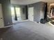Spacious living room featuring neutral carpet, access to a deck, and ample natural light at 3008 N Michigan Rd, Shelbyville, IN 46176