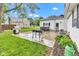 Backyard featuring an exterior view of the house, an outdoor grill, and a well-maintained lawn at 301 S B St, Thorntown, IN 46071